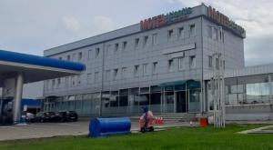 a large building with a person in front of it at Motel Atlantis in Prijedor