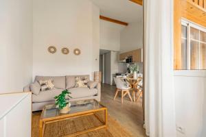 a living room with a couch and a table at Nagaya - Petit nid avec terrasse à 100m du bassin in La Teste-de-Buch