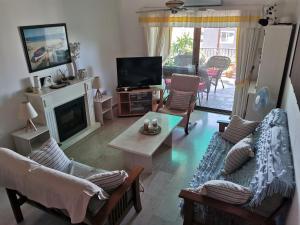a living room with couches and a tv and a fireplace at MEDITERRANEAN VALLEY in Paphos