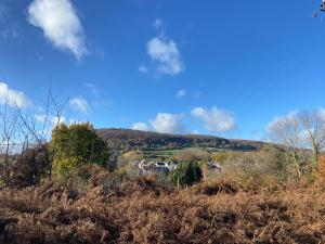 a house on top of a hill in a field at Modern 2 bed nestled in the Abergavenny hills in Abergavenny