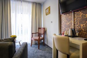 a hotel room with a desk and a chair at Hotel Villa Harmony in Sarajevo