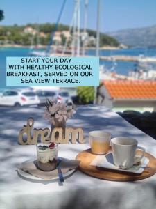 a picture of two cups of coffee on a table at ECO Aparthotel The Dreamers's Club in Lumbarda