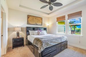 a bedroom with a bed and a ceiling fan at Pili Mai 1L in Koloa