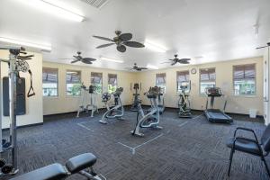 a fitness room with treadmills and exercise bikes at Pili Mai 1L in Koloa