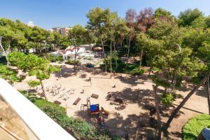 an overhead view of a park with a playground at UHC Central Park Apartments in Salou