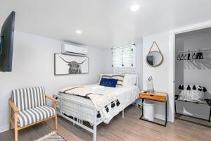 a bedroom with a bed and a chair at East Nashville Nook Best of Both Worlds in Nashville