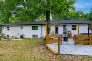 a white house with a fence in front of it at East Nashville Nook Best of Both Worlds in Nashville