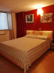een slaapkamer met een bed in een rode kamer bij La Casa Del Peperoncino Rosso in Quartu SantʼElena