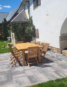 a wooden table and four chairs sitting around it at Baroque villa near Bled - Resort Vidmar in Lesce