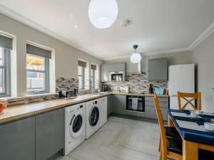 a kitchen with a washer and dryer at Westertonhill Lodge 3 with Hot Tub Option in Balloch