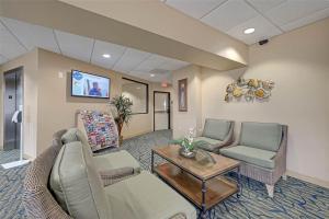 a waiting room with a couch and chairs and a table at Casa Del Mar Skip to the Beach 294 in Galveston