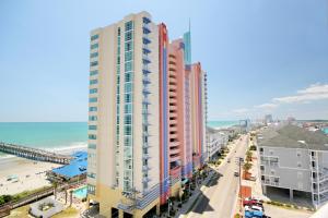 a view of the beach from the balcony of a building at Prince Resort Oceanfront 1834 at Cherry Grove Pier in Myrtle Beach