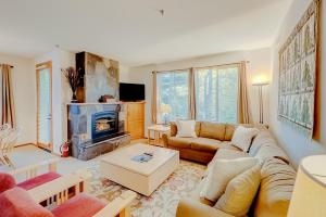 a living room with a couch and a fireplace at Ski-In Ski-Out Squaw Valley Lodge Slopeside Townhome in Olympic Valley