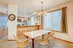 a dining room with a table and chairs and a clock at Ski-In Ski-Out Squaw Valley Lodge Slopeside Townhome in Olympic Valley