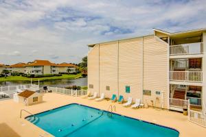 a swimming pool in front of a building at Beach Cottage at OD in Myrtle Beach