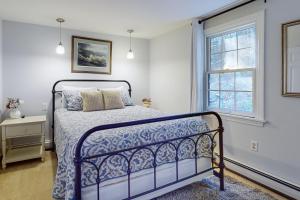 a bedroom with a bed and a window at Quechee Hollow Comfort in White River Junction +68 photos