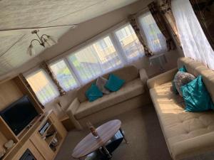 a living room with a couch and a tv at BUTLINS SKEGNESS, 3 Beds, Pet Friendly - The Paddock in Lincolnshire