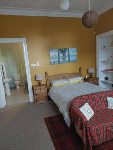 a bedroom with a bed and a couch in it at Bank House in Thurso