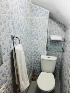 a bathroom with a white toilet and a towel at Hostel Amour d'auberge in Marrakesh