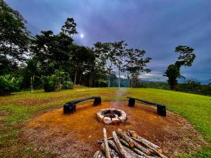 a fire pit in the middle of a field at Hotel Los Cielos Del Caribe in Cahuita