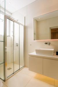 a bathroom with a sink and a shower at Cove Seaview Villas - Neptune in Ayia Napa