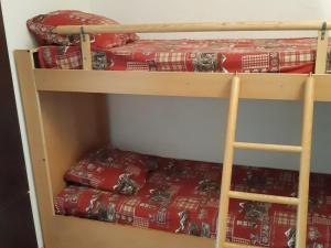 two bunk beds in a room with red blankets at Studio Les Deux Alpes, 1 pièce, 4 personnes - FR-1-516-51 in Les Deux Alpes
