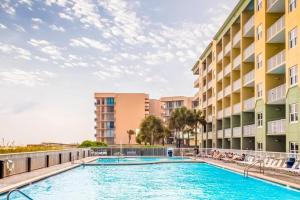 a swimming pool in front of a building at Water's Edge 301 in Fort Walton Beach