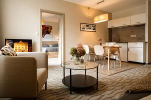 a living room with a couch and a table at Hygge Hotel U Zvonu in Vrchlabí