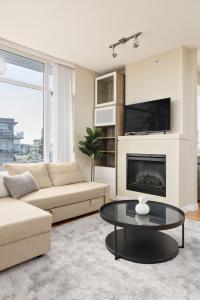 a living room with a couch and a fireplace at Lovely 2 Bedroom condo with indoor Fireplace for 6 in Burnaby