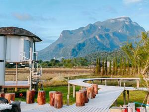 a wooden walkway with a mountain in the background at ดูดอยคอยดาว Dodoykoydao 