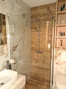 a bathroom with a shower and a toilet and a sink at LA FORESTA LUX apartment Jahorina in Jahorina
