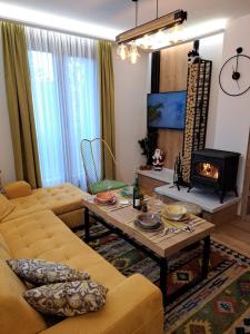 a living room with a couch and a fireplace at LA FORESTA LUX apartment Jahorina in Jahorina +36 photos