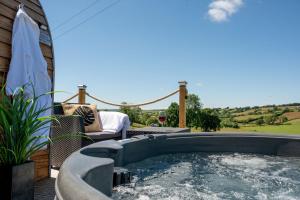 a hot tub on the patio of a house at Bedwen in Welshpool