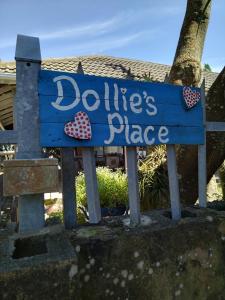 una señal azul para un lugar de dolitts en Dollies place, en Bazley Beach