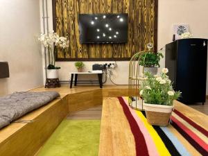 a living room with a flat screen tv on a wall at Ipoh Family Homestay Masjid Muhammadiah Evicharger SY16 in Ipoh