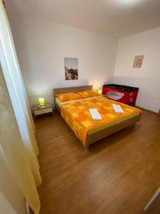 a bedroom with a bed and a red suitcase at Bright and spacious apartment with outdoor space in Kaštela