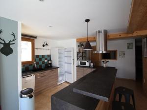 a kitchen with a black counter top in a room at Appartement Valloire, 3 pièces, 6 personnes - FR-1-263-466 in Valloire