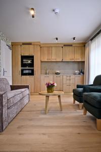 a living room with a couch and a table at Bachmair Weissach See-Apartments in Rottach-Egern