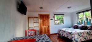 a small room with a bed and a window at Henua Roa Loft in Hanga Roa