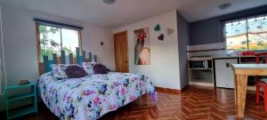 a bedroom with a bed and a table in it at Henua Roa Loft in Hanga Roa