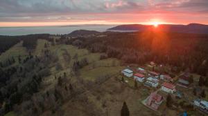 una vista aérea de una casa con la puesta de sol en el fondo en Horská bouda Schmitke výhled Klínovec, en Jáchymov