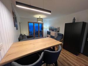 a dining room with a wooden table and chairs at Cosy studio for 4 near ski lift, MELEZES K22 in Veysonnaz
