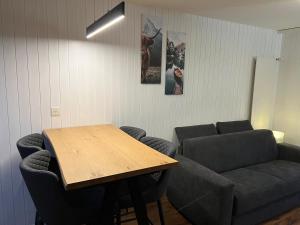 a living room with a table and a couch at Cosy studio for 4 near ski lift, MELEZES K22 in Veysonnaz