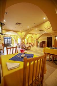 a dining room with yellow tables and chairs at Marina view port ghalib in Port Ghalib