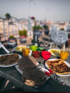 stół z talerzami żywności na górze w obiekcie Hostel Essassi 23 w Marakeszu