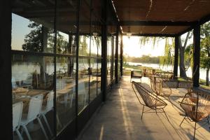 a patio with tables and chairs and a building at Bodega Trina Suites in Río Colorado