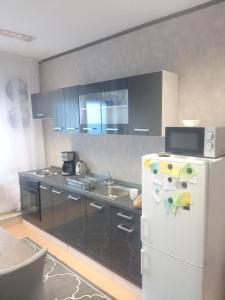 a kitchen with a white refrigerator and a sink at Ferienwohnung mit Whrpool in Koblenz