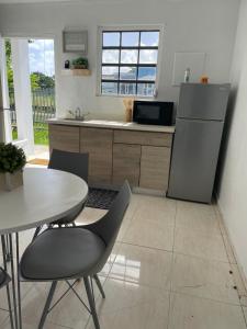 a kitchen with a table and a table and chairs at Las Olas Beach apartments in Arecibo +35 photos