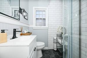 a white bathroom with a toilet and a shower at Shaker Heights- WiFi, 1st Floor in Shaker Heights