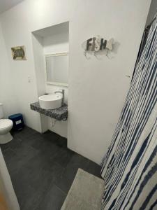 a bathroom with a sink and a toilet at Las Olas Beach apartments in Arecibo